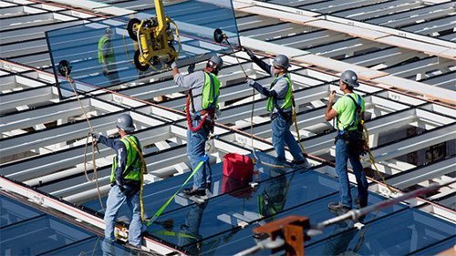 men working on roof scaffolding