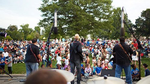 people on stage playing music for a crowd